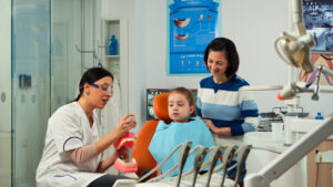 Parent bringing child to a dentist appointment under the Child Dental Benefits Schedule in Australia