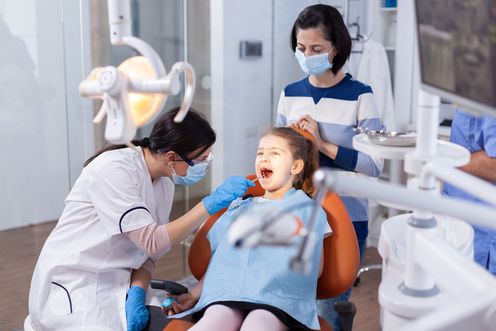 children’s dentist checking a kid's teeth
